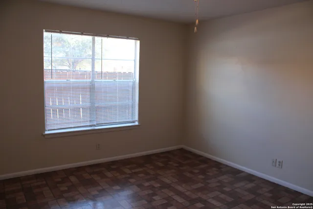 a view of an empty room with closet area