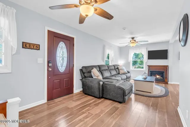 a living room with fireplace furniture and a wooden floor