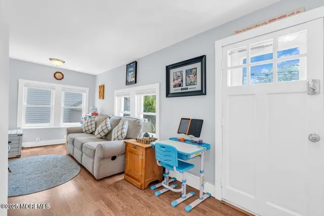 a living room with furniture a rug and a window