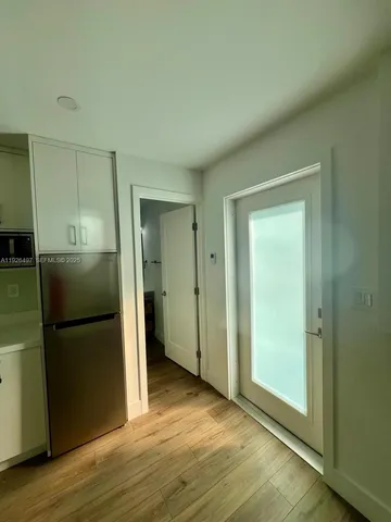 a view of a kitchen from a hallway