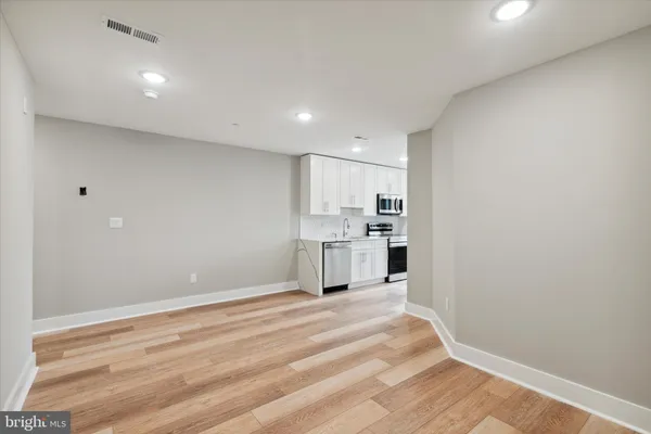 a view of a kitchen with wooden floor