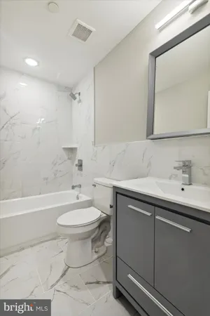 a bathroom with a sink toilet and a bathtub