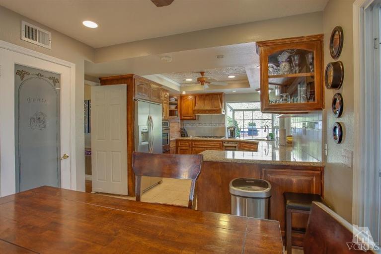 3606 Claridge Court Simi Valley, CA 93063 - Photo 17 of 58 a room with stainless steel appliances kitchen island granite countertop furniture and a refrigerator