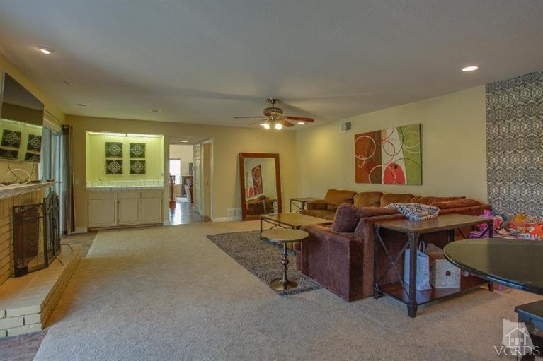 3606 Claridge Court Simi Valley, CA 93063 - Photo 26 of 58 a living room with furniture a dining table and a fireplace