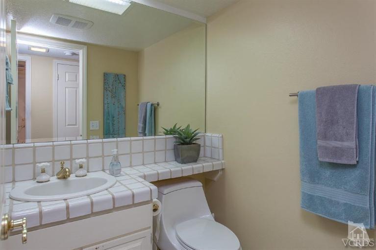 3606 Claridge Court Simi Valley, CA 93063 - Photo 28 of 58 a bathroom with a toilet a sink and mirror