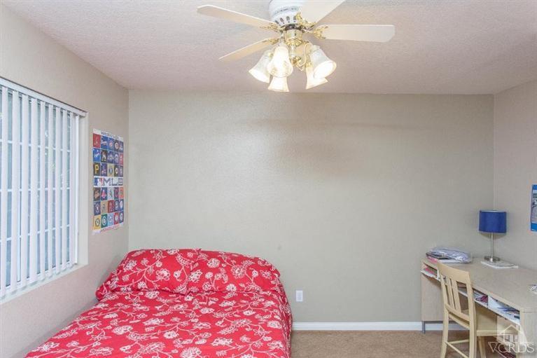 3606 Claridge Court Simi Valley, CA 93063 - Photo 32 of 58 a bedroom with a bed and a chandelier