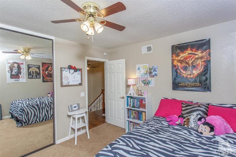 3606 Claridge Court Simi Valley, CA 93063 - Photo 36 of 58 a bedroom with furniture and a chandelier