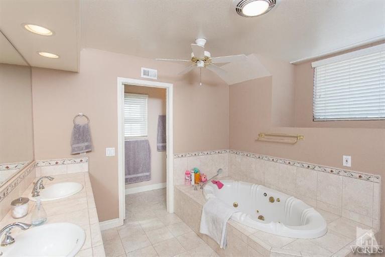 3606 Claridge Court Simi Valley, CA 93063 - Photo 43 of 58 a bathroom with a bathtub a sink and a window