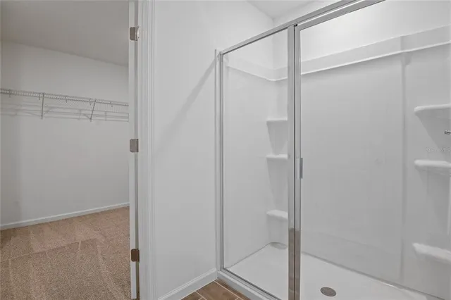 a bathroom with a glass shower door