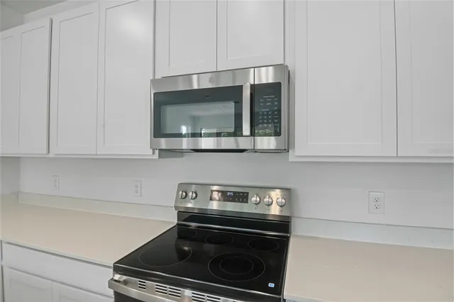 a kitchen with a stove and a microwave