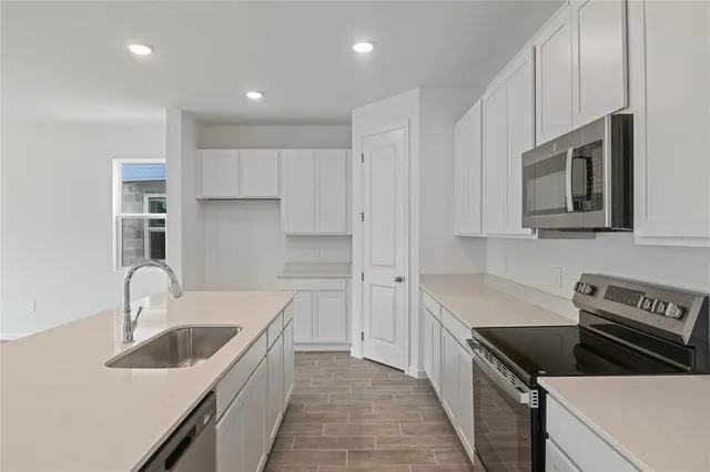a kitchen that has a sink and a stove