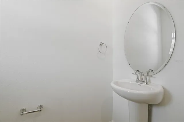 a bathroom with a sink and mirror