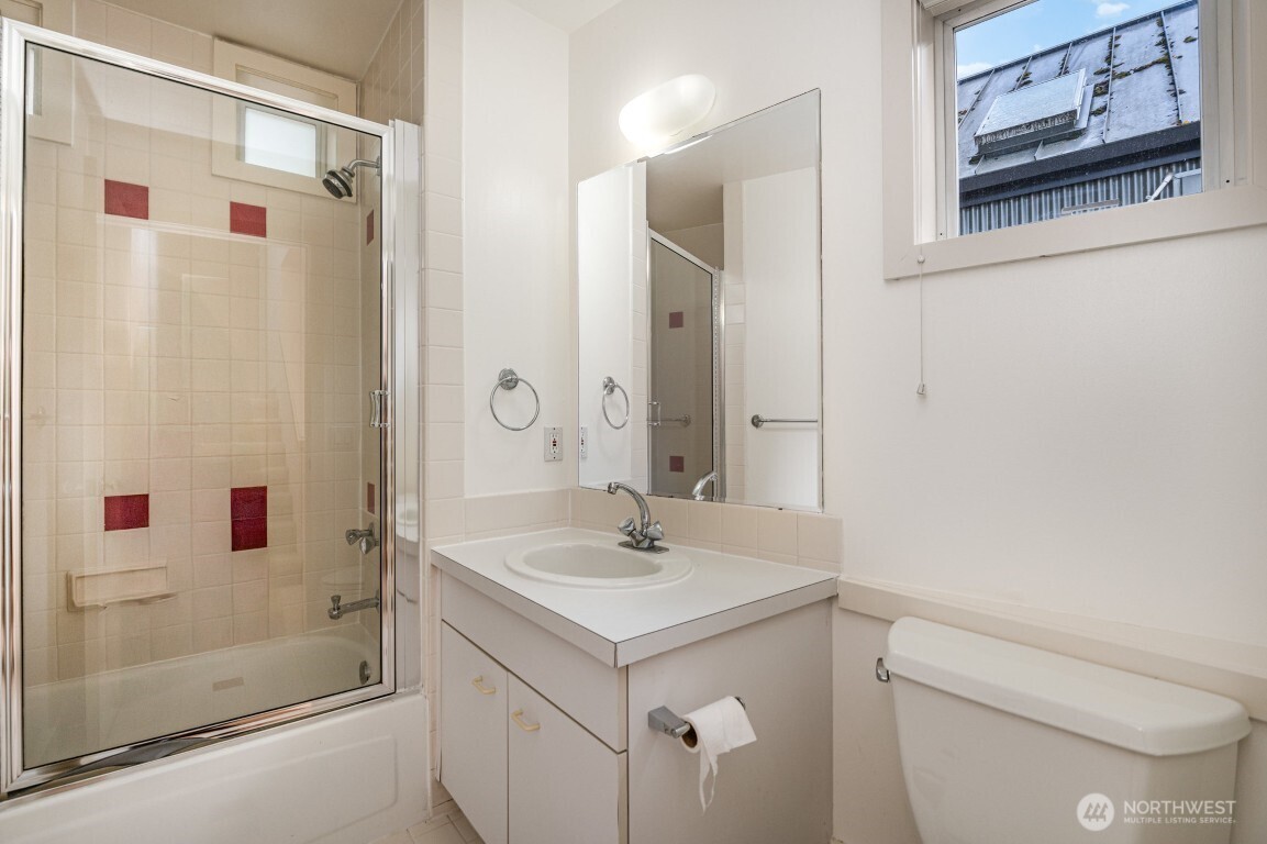 2216 19th Avenue East Seattle, WA 98112 - Photo 15 of 23 a bathroom with a sink toilet and shower