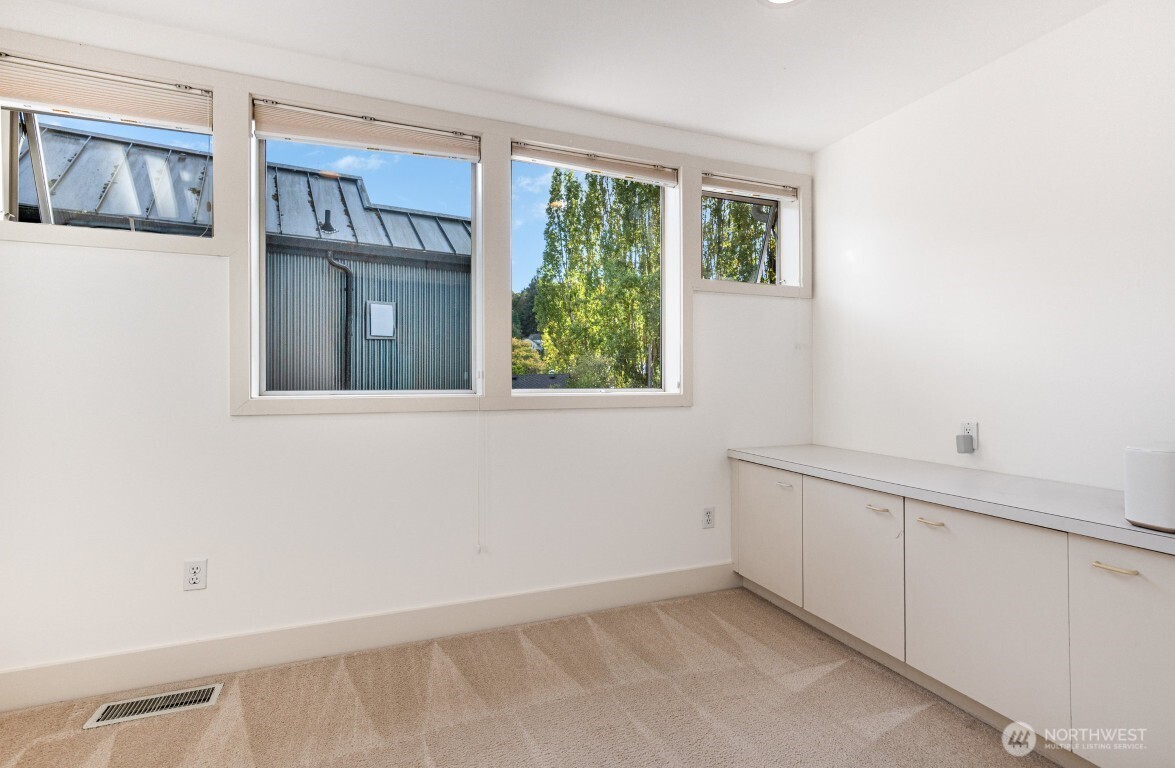 2216 19th Avenue East Seattle, WA 98112 - Photo 16 of 23 a view of an empty room with a window