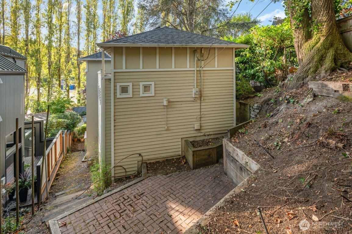 2216 19th Avenue East Seattle, WA 98112 - Photo 22 of 23 a brick house with a yard and large tree