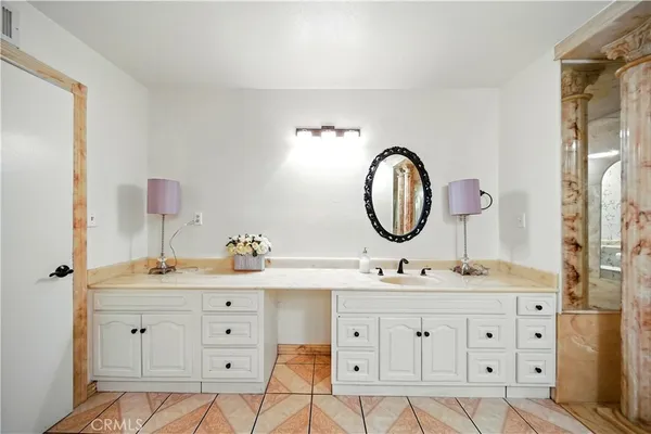 a bathroom with a double vanity sink mirror and shower