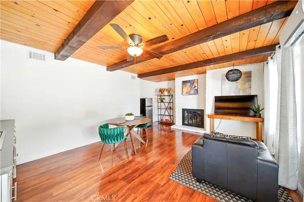 a dining room with furniture a fireplace and wooden floor