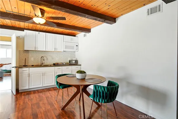 a kitchen with white cabinets and sink
