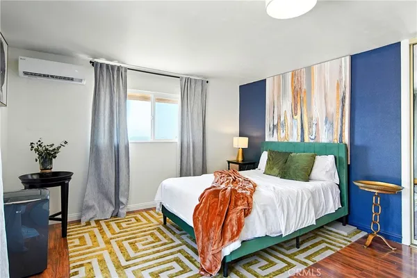 a bedroom with a bed a couch and dresser