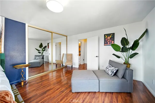 a bed sitting in a spacious bedroom next to a window