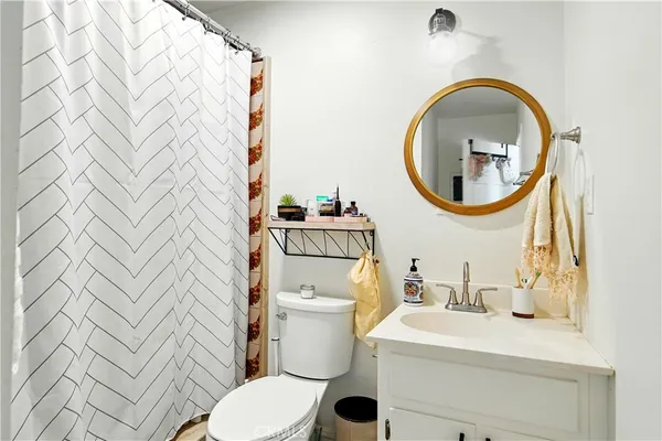 a balcony of a house with wooden floor outdoor seating and barbeque oven