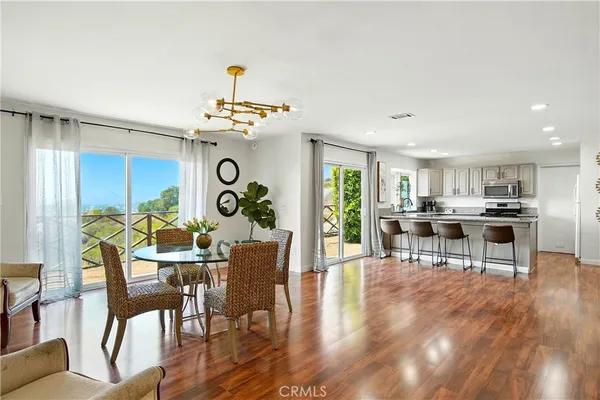 a dining room with furniture and wooden floor