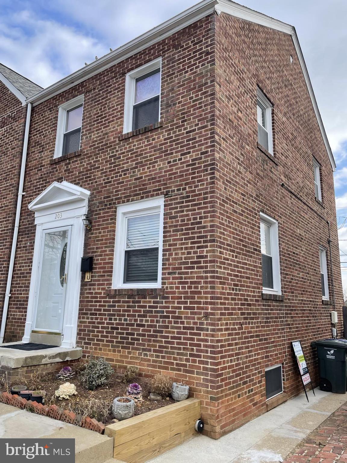 203 South Courthouse Road Arlington, VA 22204 - Photo 4 of 43 a brick building with a bench and a potted plant