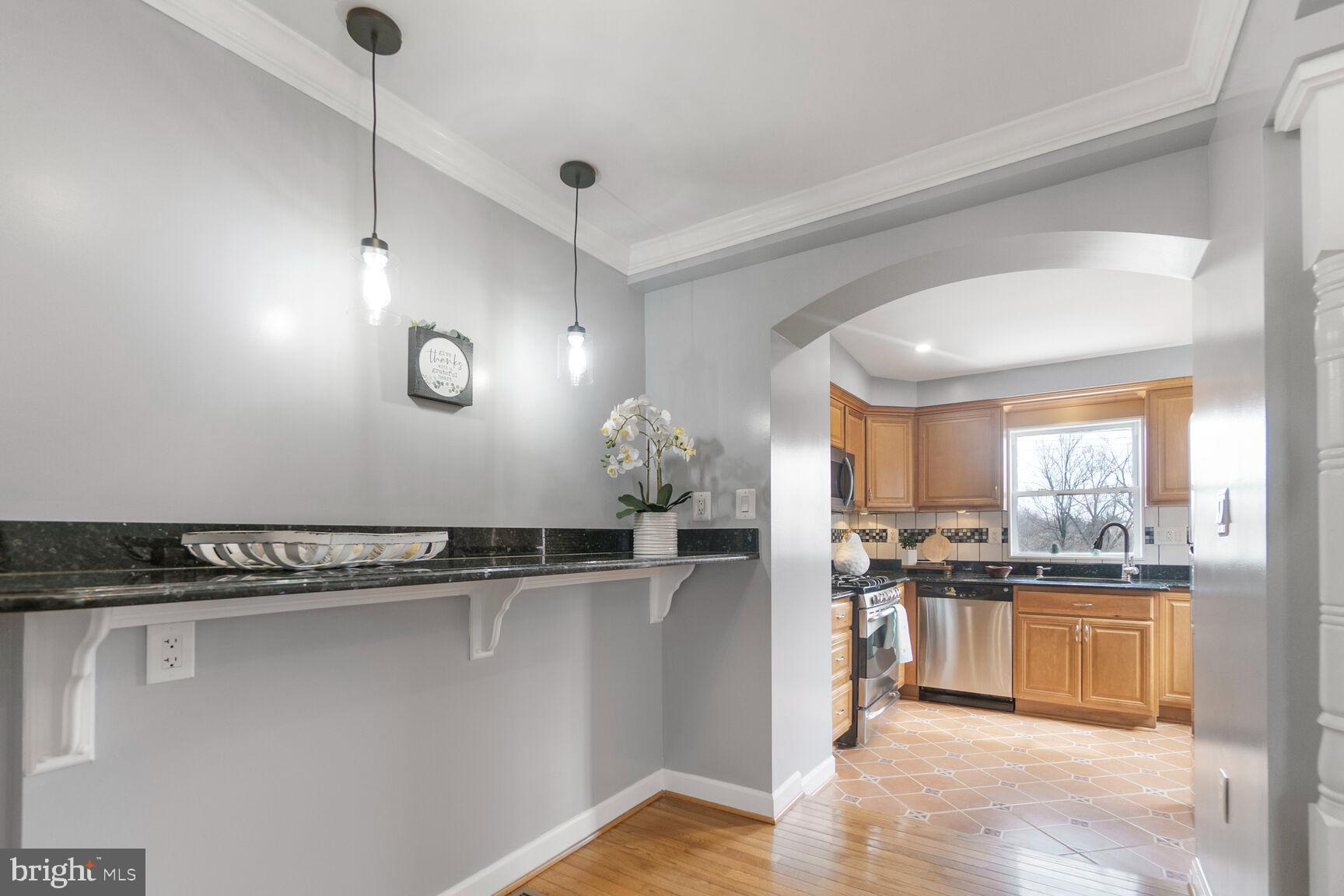 203 South Courthouse Road Arlington, VA 22204 - Photo 10 of 43 a kitchen with stainless steel appliances granite countertop a sink a stove and a refrigerator
