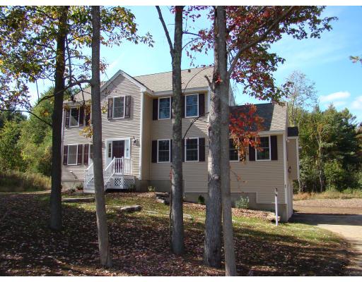66 Parker Road Shirley, MA 01464 - Photo 2 of 24 a view of a white house next to a yard with big trees
