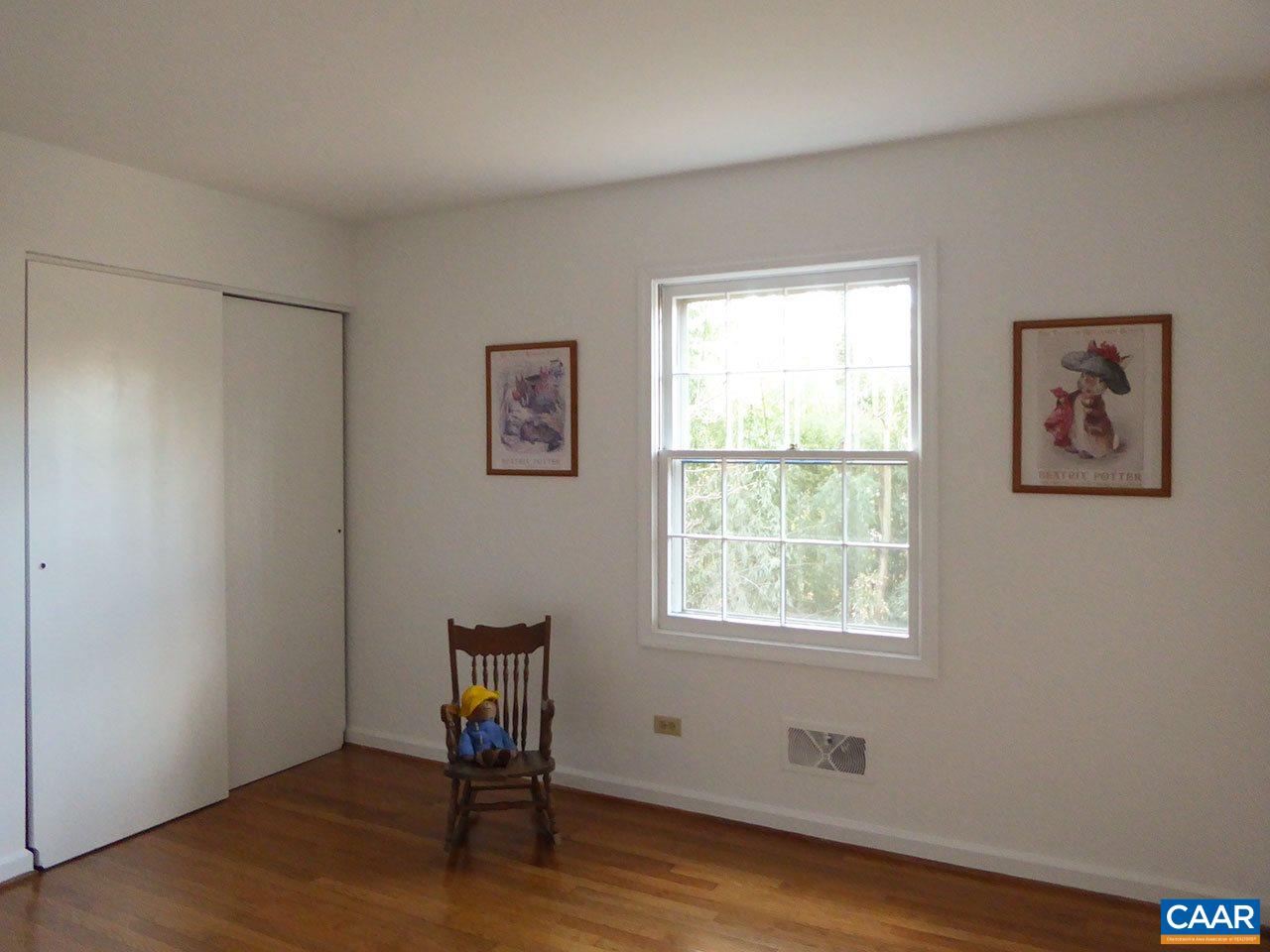 720 Village Road Charlottesville, VA 22903 - Photo 14 of 22 a view of an empty room with wooden floor and a window