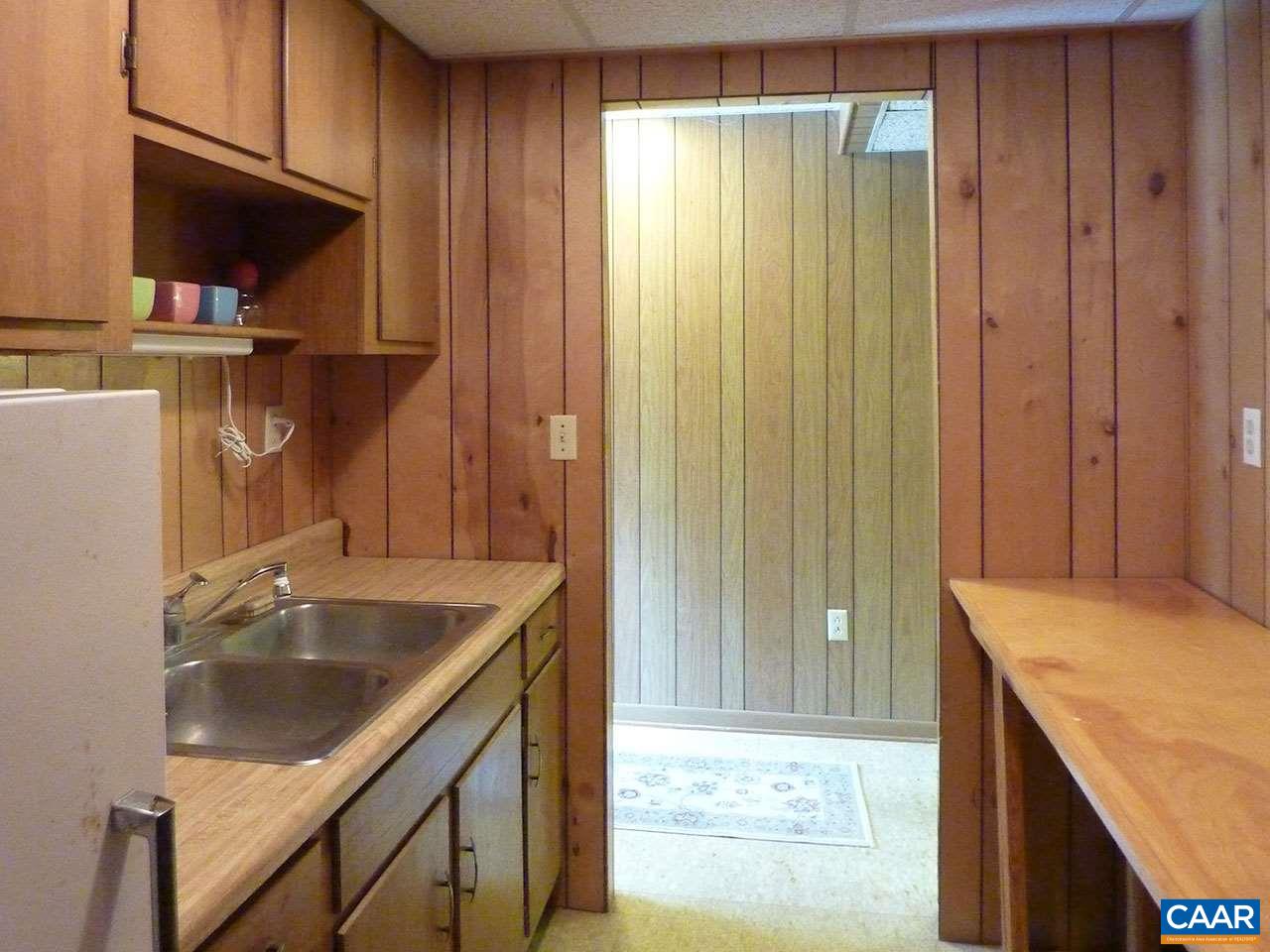 720 Village Road Charlottesville, VA 22903 - Photo 20 of 22 a kitchen with a sink a stove and cabinets