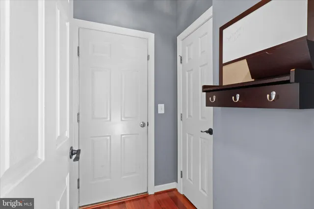 a view of a hallway with cabinets