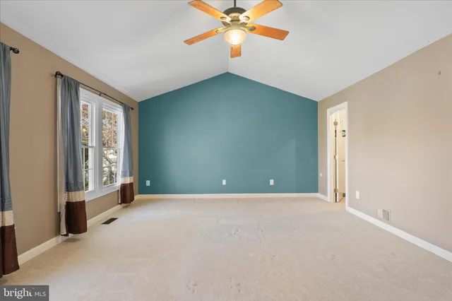 a view of a livingroom with a ceiling fan and window