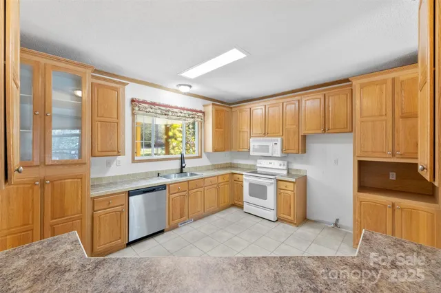 a kitchen with stainless steel appliances granite countertop a sink and a stove