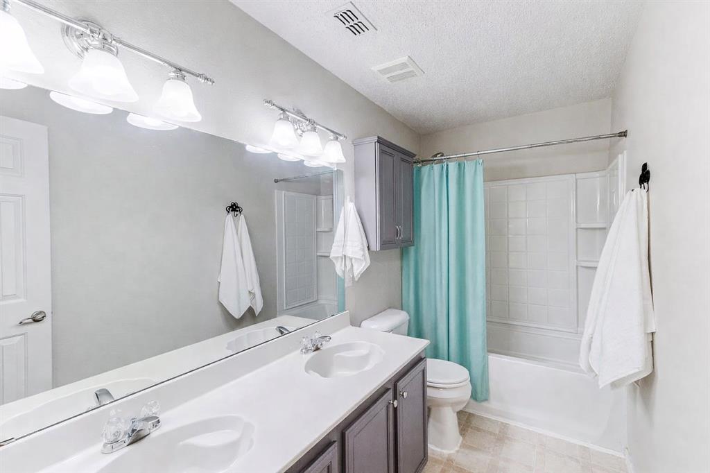 3601 McClintick Road McKinney, TX 75070 - Photo 23 of 24 a bathroom with a sink a toilet and shower