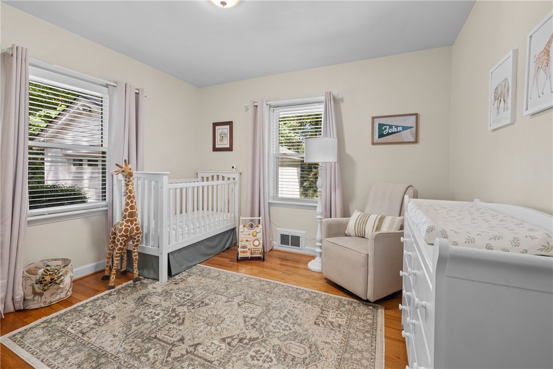 203 Augusta Road Clemson, SC 29631 - Photo 20 of 31 A well-lit nursery features warm hardwood floors and ample natural light from two windows.