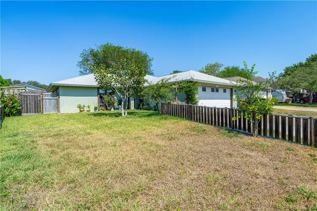 a view of a house with backyard and porch