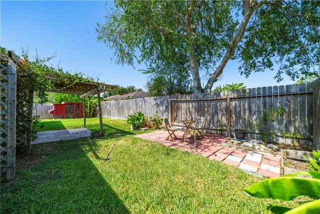 a view of a backyard with wooden fence