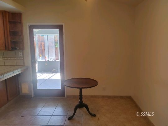 609 East Wilson Avenue Ridgecrest, CA 93555 - Photo 6 of 32 a room with a bench and a potted plant
