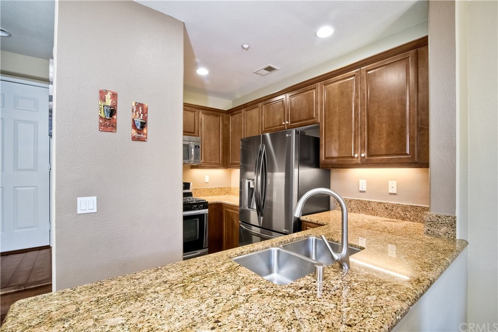 4115 Karst Road Carlsbad, CA 92010 - Photo 14 of 33 a kitchen with stainless steel appliances granite countertop a refrigerator and a sink