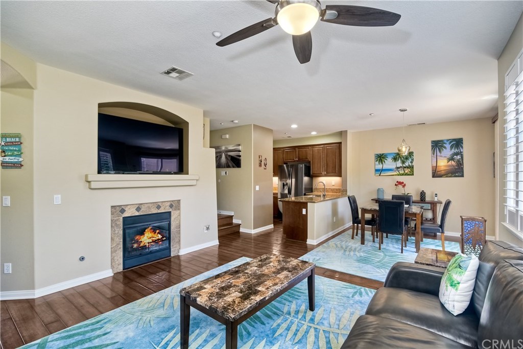 4115 Karst Road Carlsbad, CA 92010 - Photo 16 of 33 a living room with furniture a flat screen tv and a fireplace