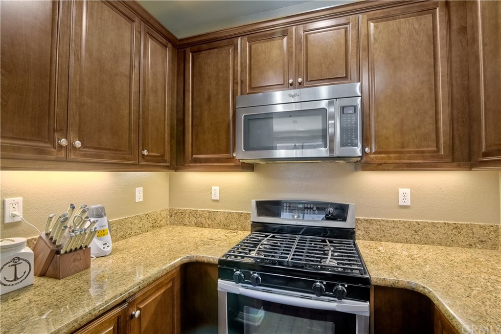 4115 Karst Road Carlsbad, CA 92010 - Photo 17 of 33 a kitchen with granite countertop a stove and a sink