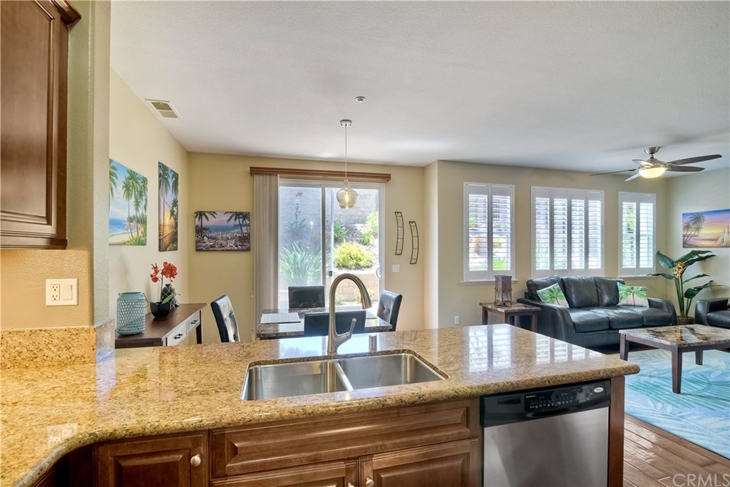 4115 Karst Road Carlsbad, CA 92010 - Photo 18 of 33 a kitchen with granite countertop a sink and living room view