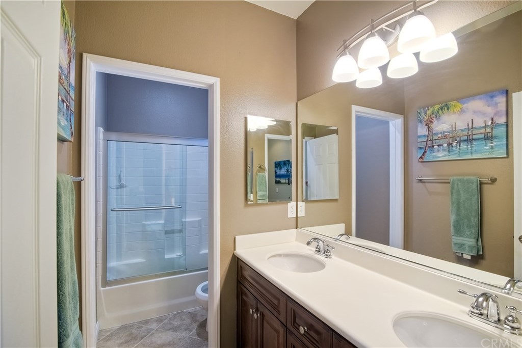 4115 Karst Road Carlsbad, CA 92010 - Photo 19 of 33 a bathroom with a double vanity sink mirror and shower