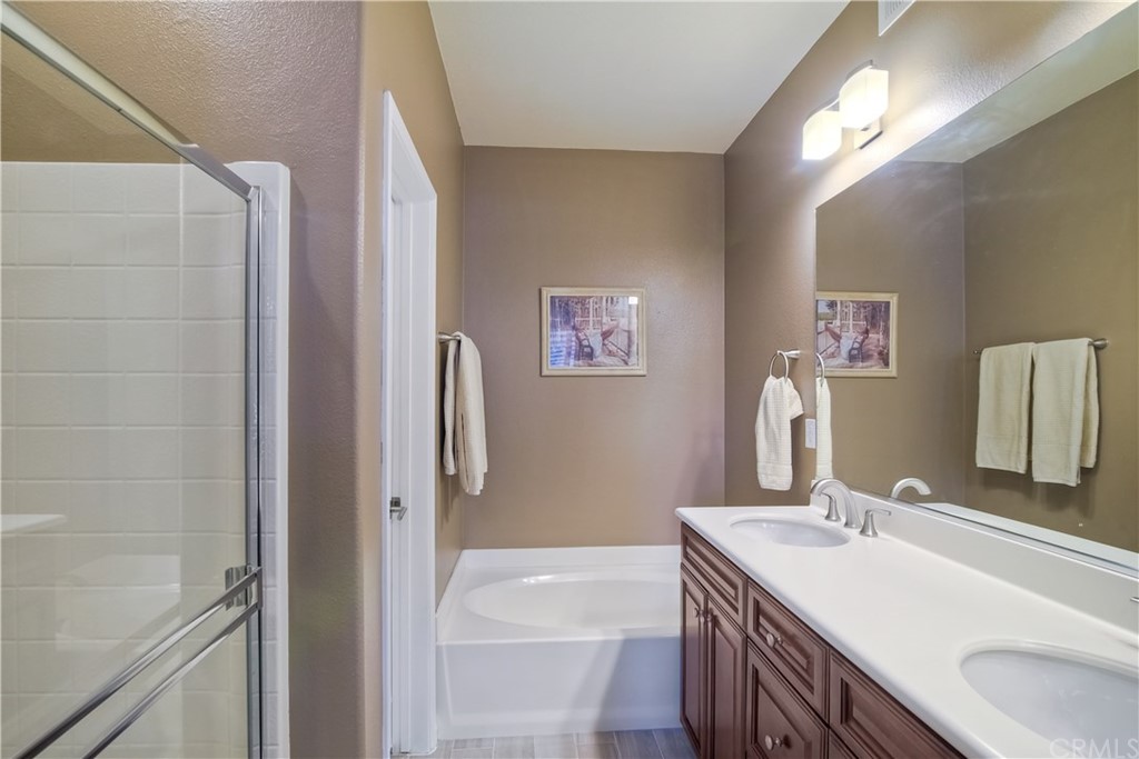 4115 Karst Road Carlsbad, CA 92010 - Photo 25 of 33 a bathroom with a sink double vanity granite tub shower and a mirror