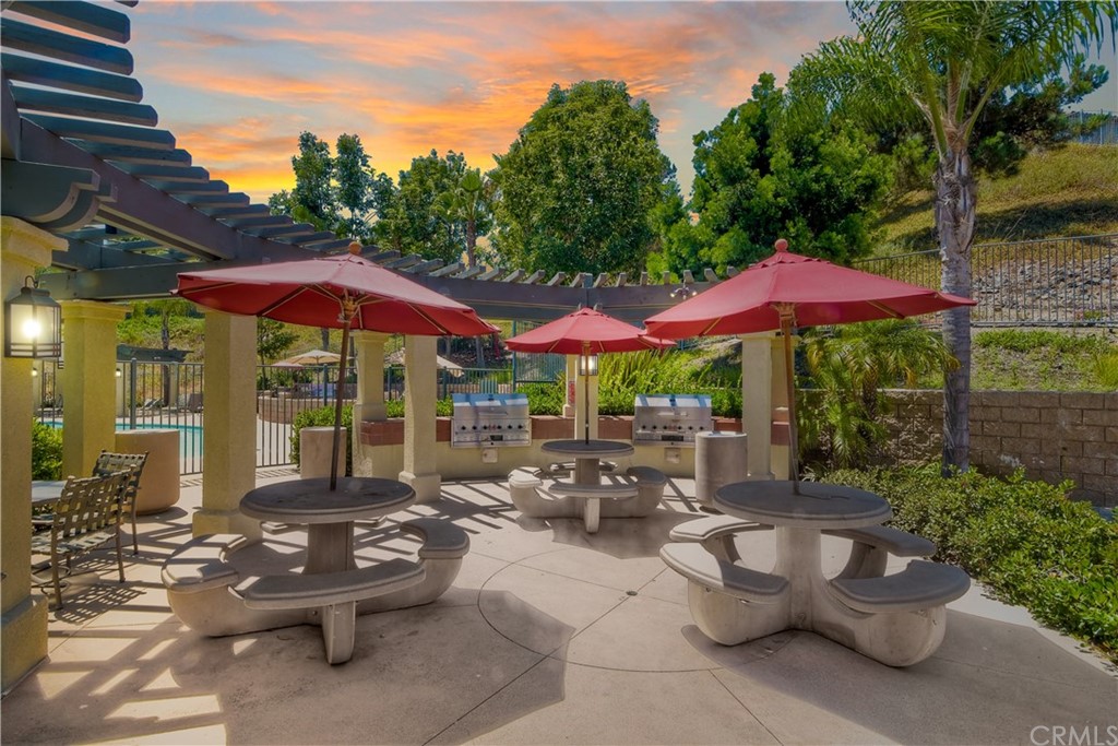 4115 Karst Road Carlsbad, CA 92010 - Photo 32 of 33 a view of a patio with chairs and table under an umbrella