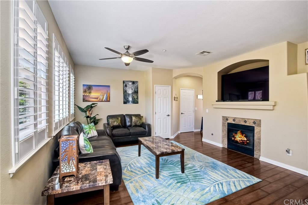 4115 Karst Road Carlsbad, CA 92010 - Photo 8 of 33 a living room with furniture a flat screen tv and a fireplace