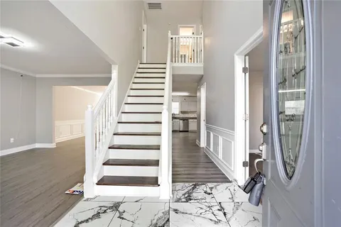 a view of a hallway with windows and stairs