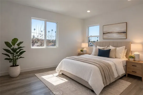 a bedroom with bed and a potted plant