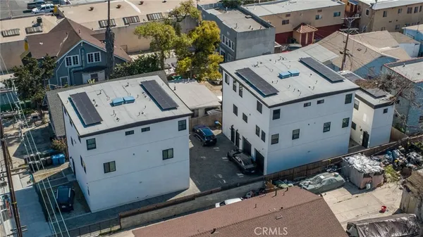 an aerial view of a house with a yard